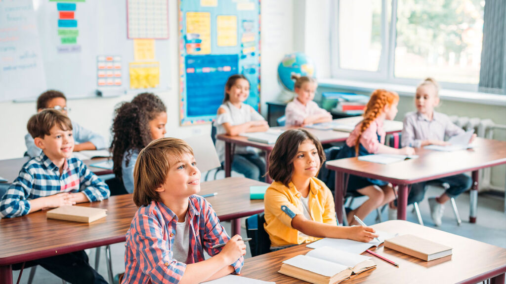 Students with books in classroom