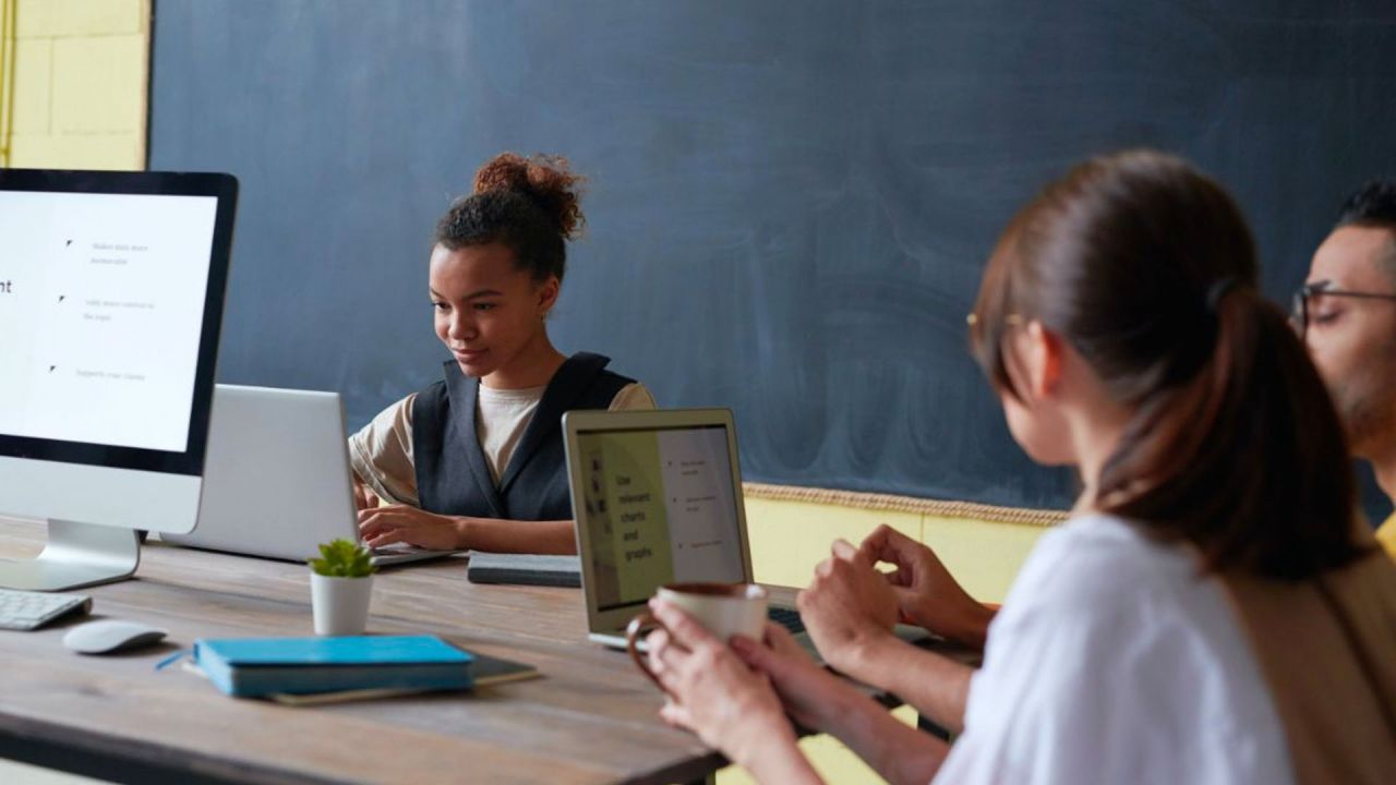 students working together at computers in a classroom