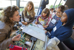 teacher showing the inside of a computer to students
