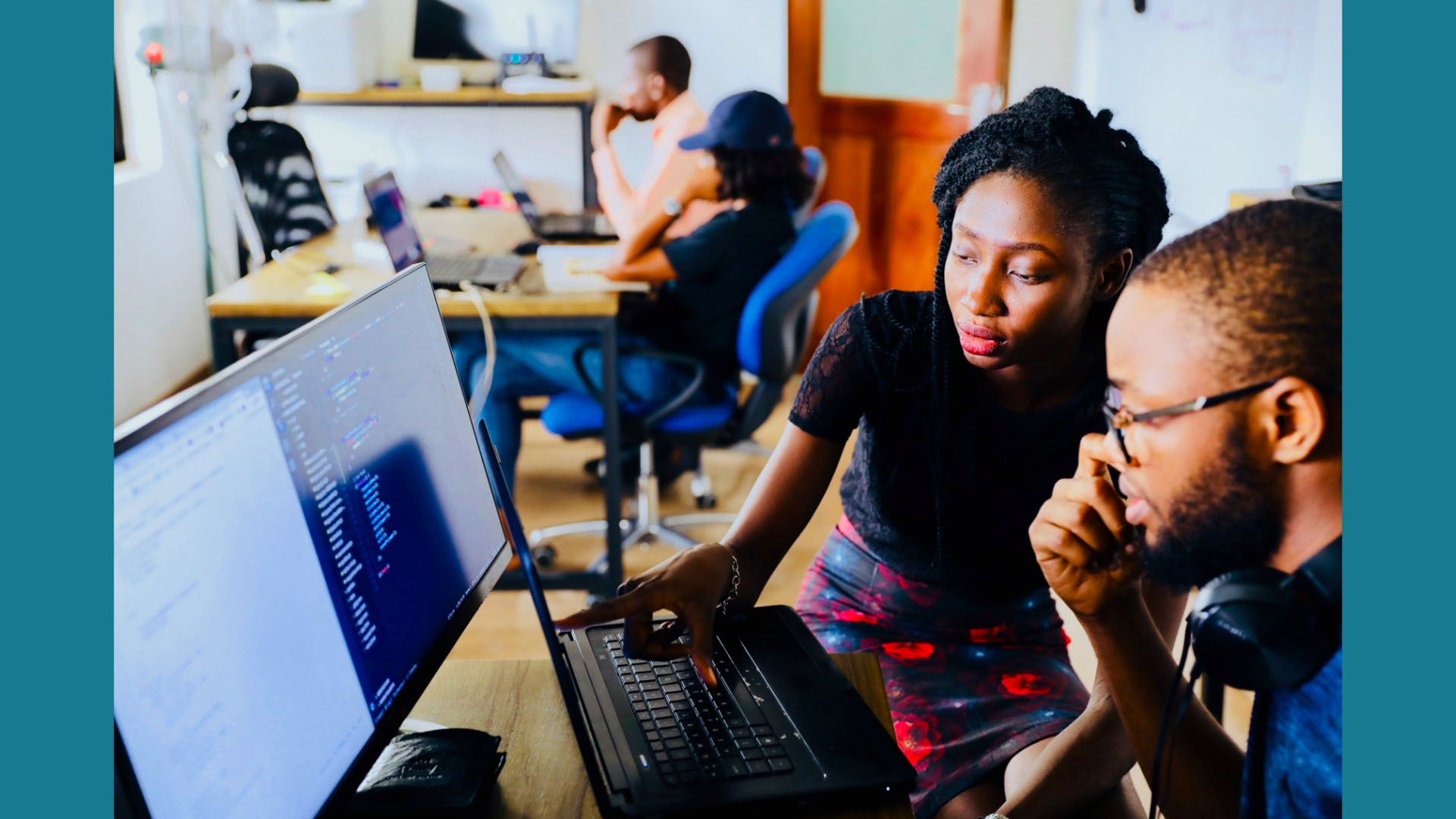 KInL - Math Thinking Classroom teacher helping student on a computer