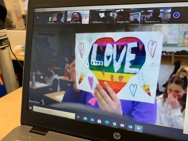 zoom classroom with student showing off drawing