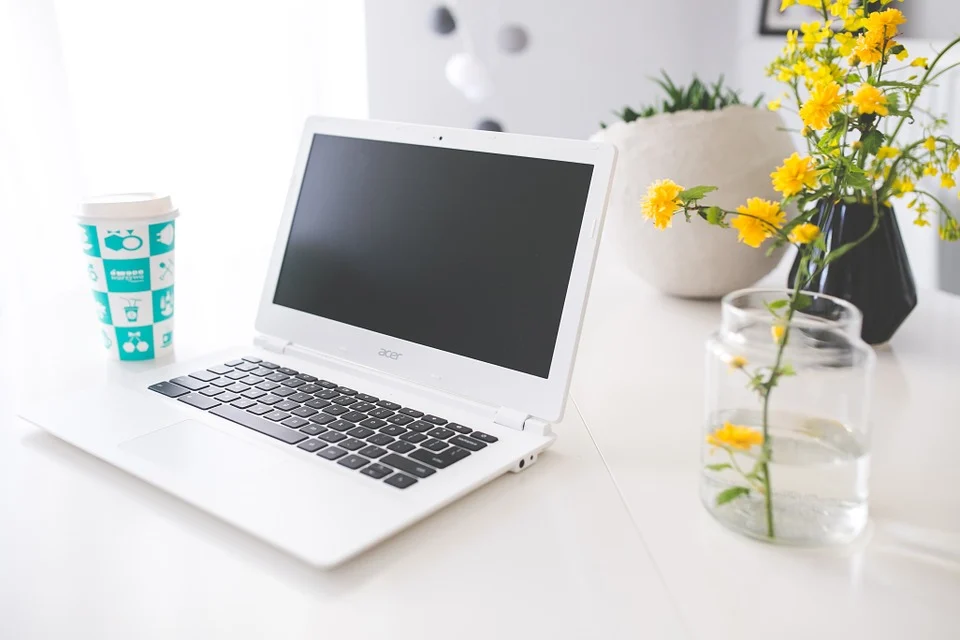 Laptop on desk laptop on desk next to a coffee cup