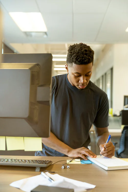 Student writing at a computer