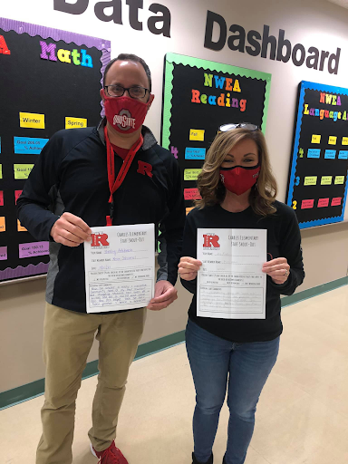 Teachers holding papers in their hands