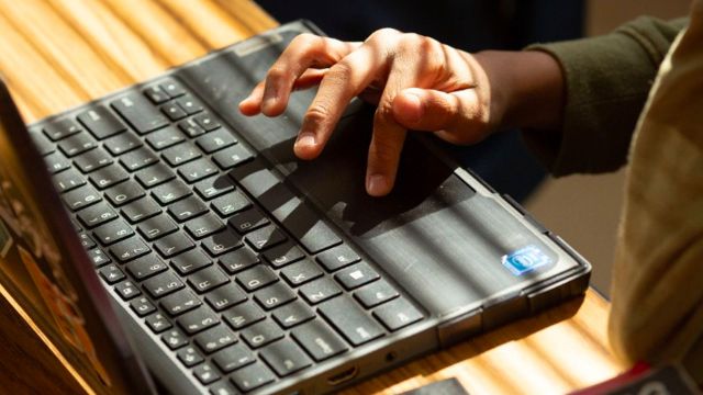 hands typing on a laptop