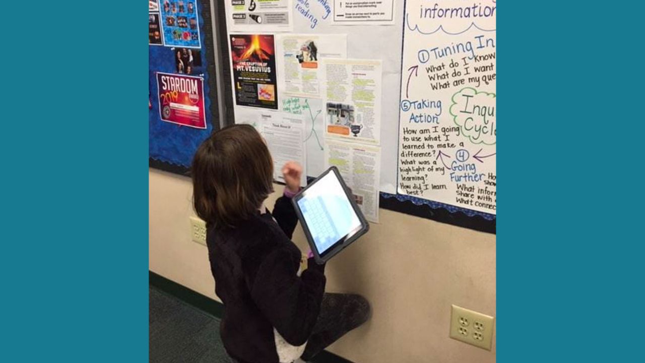 student working at an anchor chart