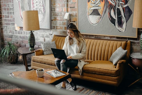 Cambridge Math woman sitting on her couch with laptop on her lap