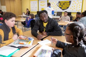 teacher having a discussion with his two students