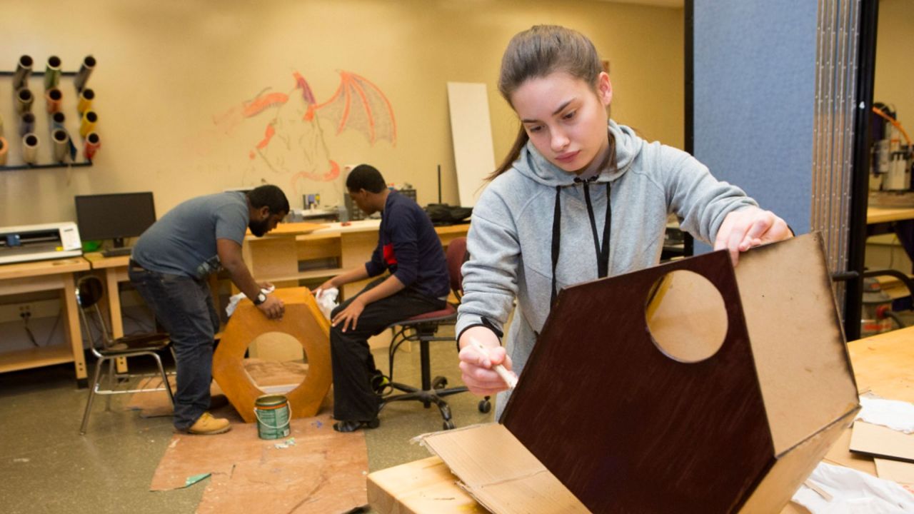 student building a wooden structure