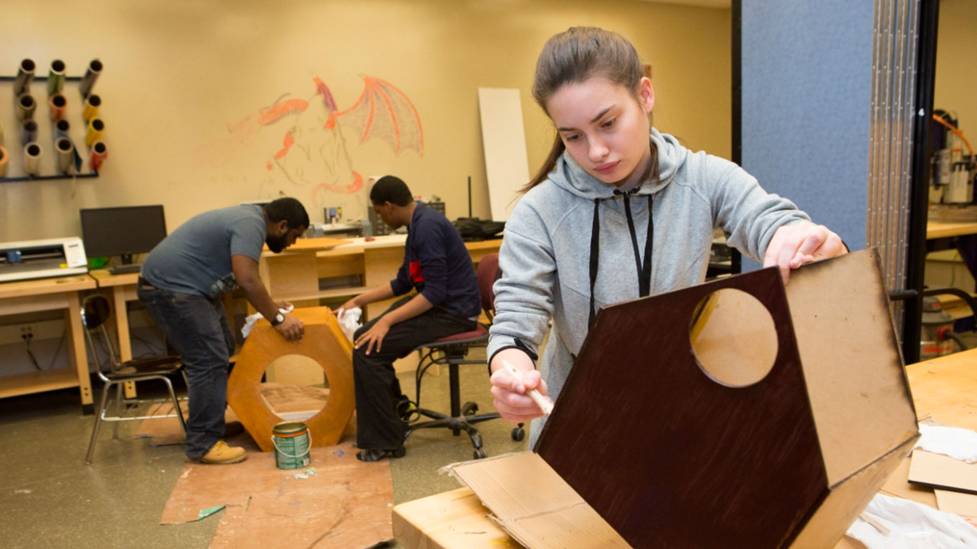 student building a wooden structure