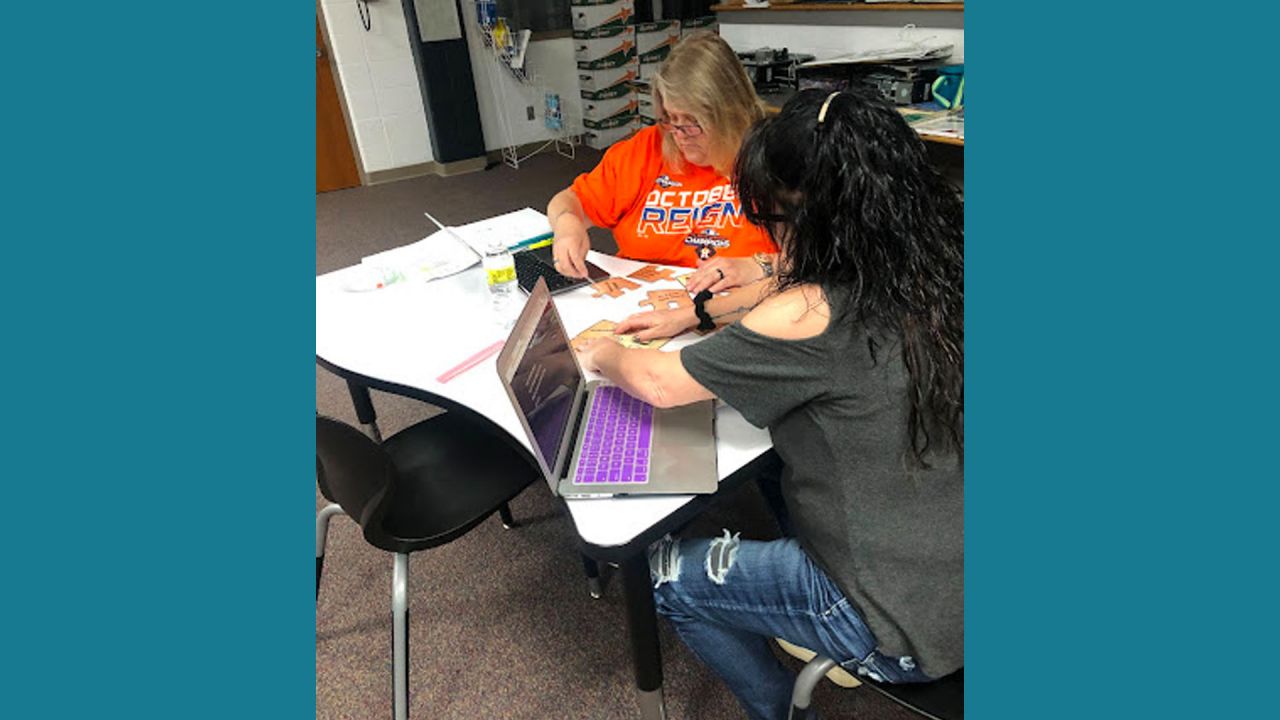 Teachers working on puzzle pieces.