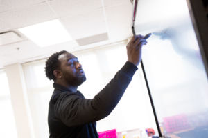 Teacher writing on the board.