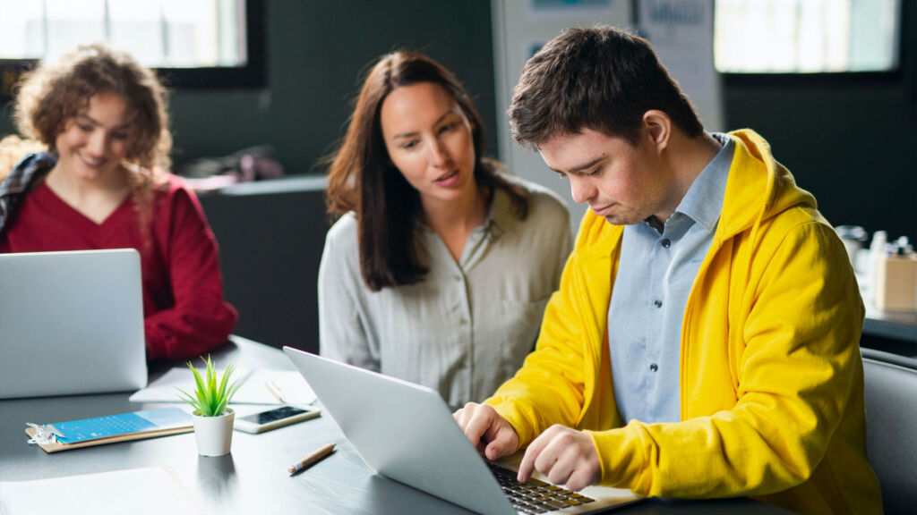 Students using a laptop in class.