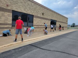 Students outside using chalk.