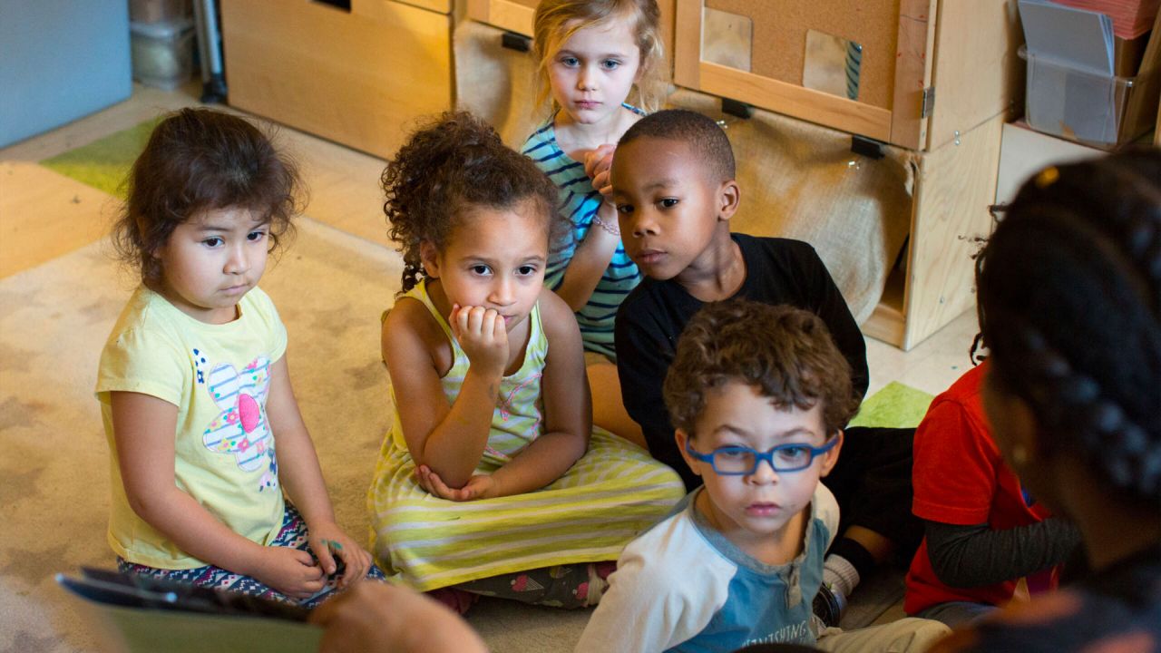 Children sitting and listening to a story.