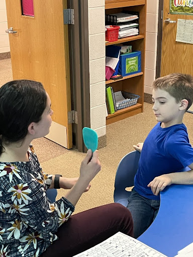 Teacher helping student Teacher using a new strategy to help students form sounds after an I notice & I wonder debrief.