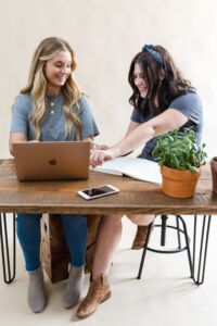 Teacher with a student, working together on a laptop.