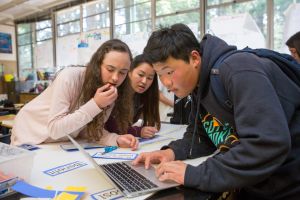 Students reviewing content on a laptop.