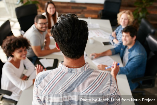 Team of people discussing plans.