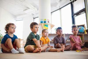 Children sitting on the floor.