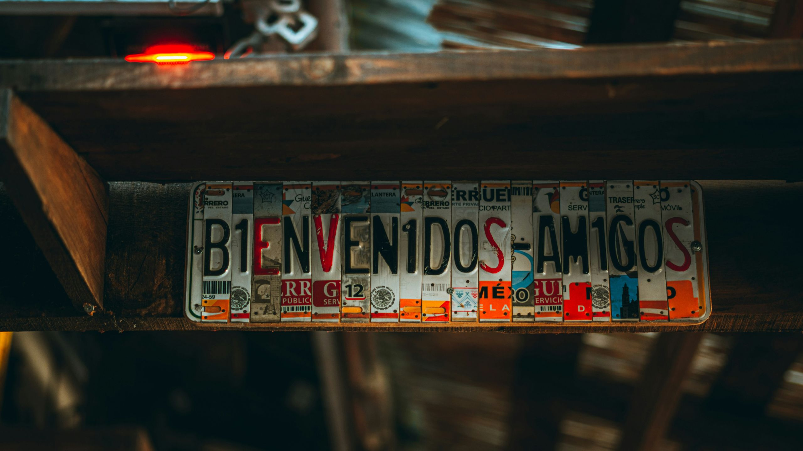 amit-ovadia-YLLpknpS8kc-unsplash License plates cut up to form the word Bienvenidos Amigos.