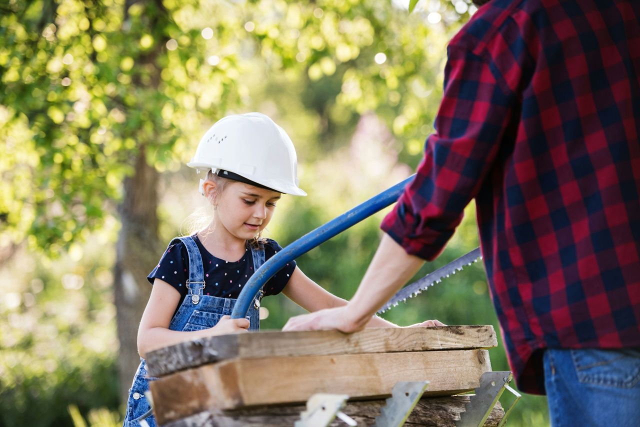 Child and Father building something together.