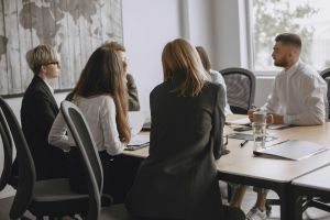 People sitting at a table having a meeting.