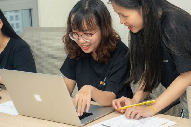 Students working on a laptop together.